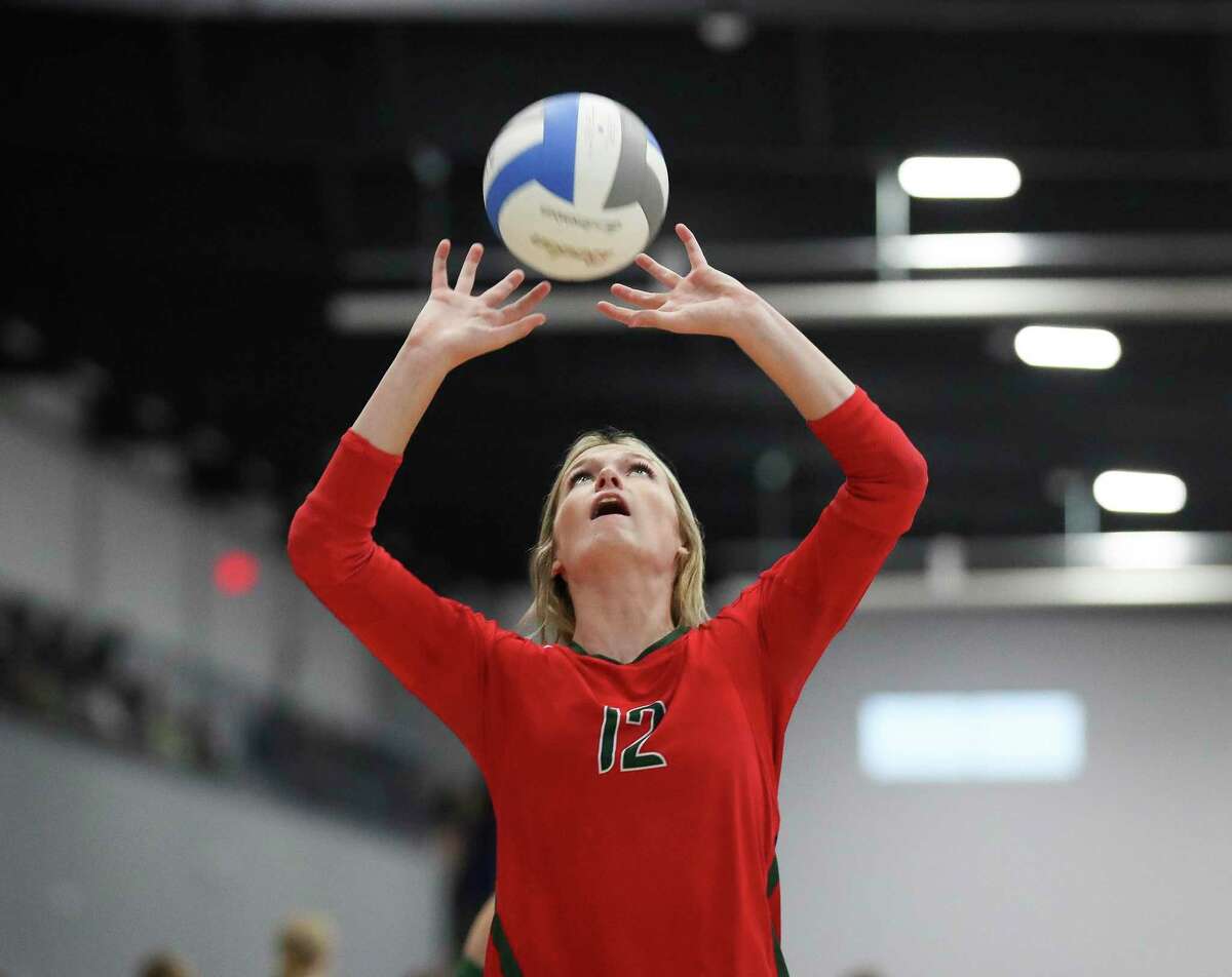 The Woodlands' Molly Tuozzo (12) sets the ball in the first set of a non-district high school volleyball match during the Adidas John Turner Classic, Friday, Aug. 12, 2022, in Webster.