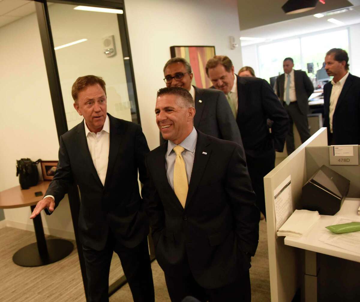 Gov. Ned Lamont, left, joins officials at KPMG for a tour of the company’s offices at 677 Washington Blvd., on July 15, 2019.