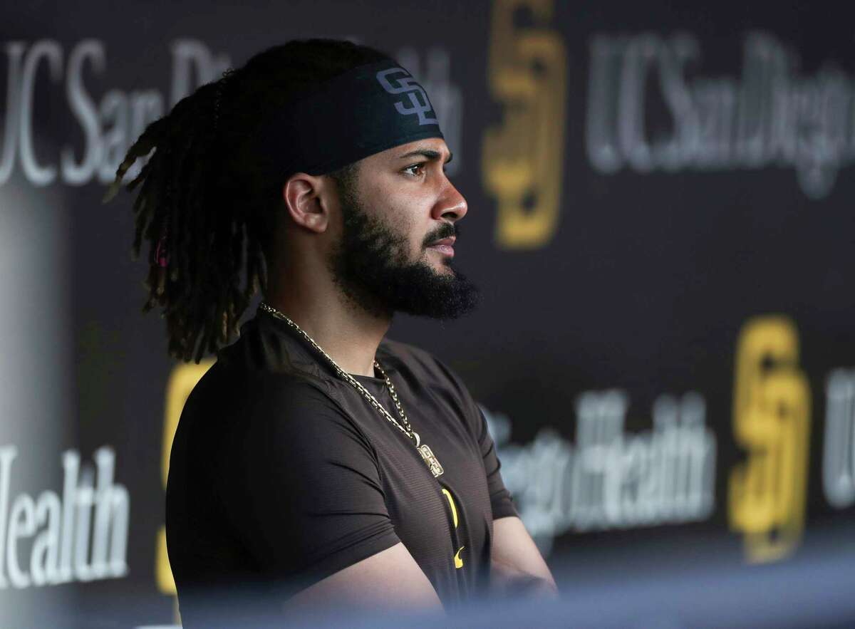 FILE - San Diego Padres' Fernando Tatis Jr. looks out from the dugout prior to the team's baseball game against the Philadelphia Phillies on June 25, 2022, in San Diego. Tatis was suspended 80 games by Major League Baseball on Friday, Aug. 12, after testing positive for a performance-enhancing substance. The penalty was effective immediately, meaning the All-Star shortstop cannot play in the majors this year. Tatis had been on the injured list all season after breaking his left wrist in spring training.