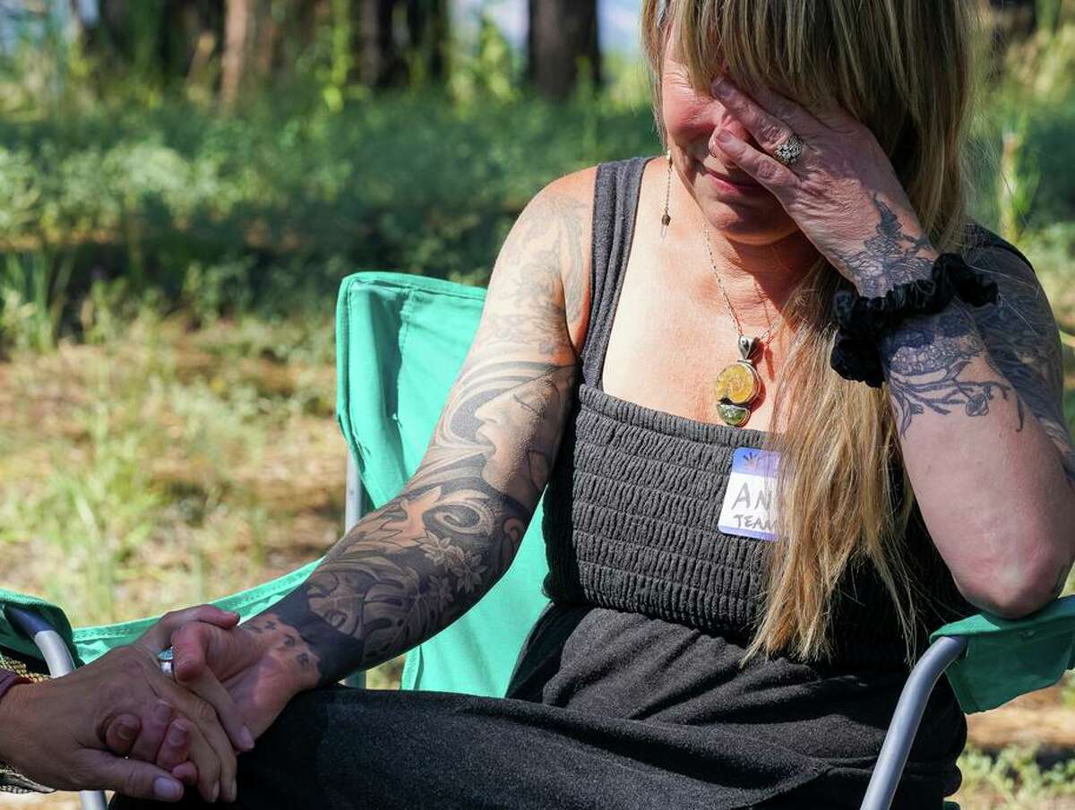Ana Larson reaches out for support while overcome with emotion as she speaks about Kiely Rodni while taking a break from volunteer efforts at the Truckee Recreation Center parking lot in Truckee, Calif., on Friday the 12th August 2022. Larson is a family friend and family spokesperson for Kiely Rodni.