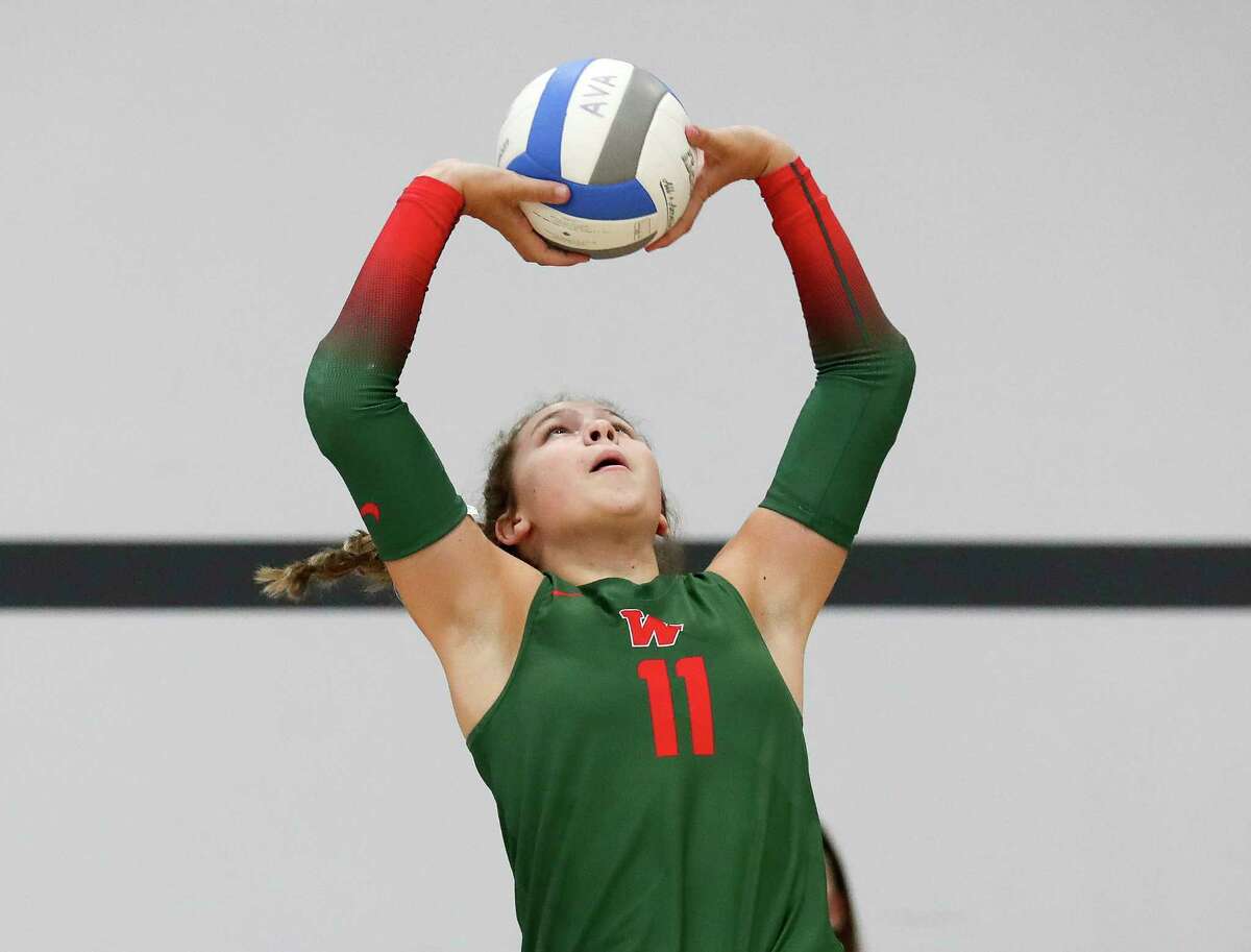 The Woodlands' Olivia Chojnacki (11) sets the ball in the first set of a non-district high school volleyball match during the Adidas John Turner Classic, Friday, Aug. 12, 2022, in Webster.