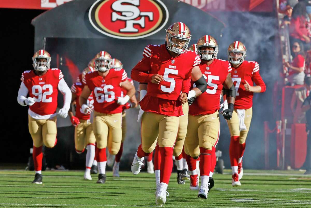 49ers quarterback Trey Lance (5) leads the team onto the field before Friday’s game against the Green Bay Packers.
