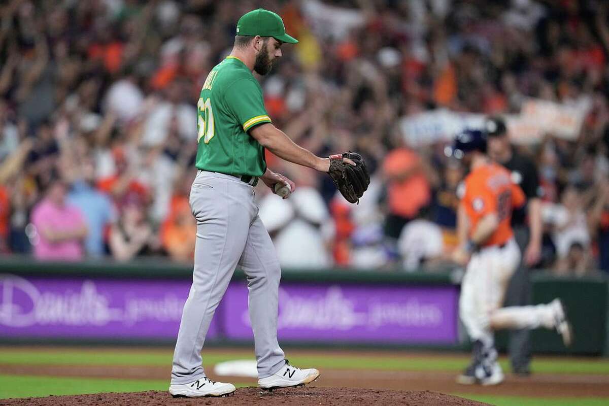Oakland Athletics relief pitcher Sam Moll walks off the mound after giving up a grand slam to Houston Astros' Kyle Tucker during the fifth inning of a baseball game Friday, Aug. 12, 2022, in Houston. (AP Photo/Kevin M. Cox)