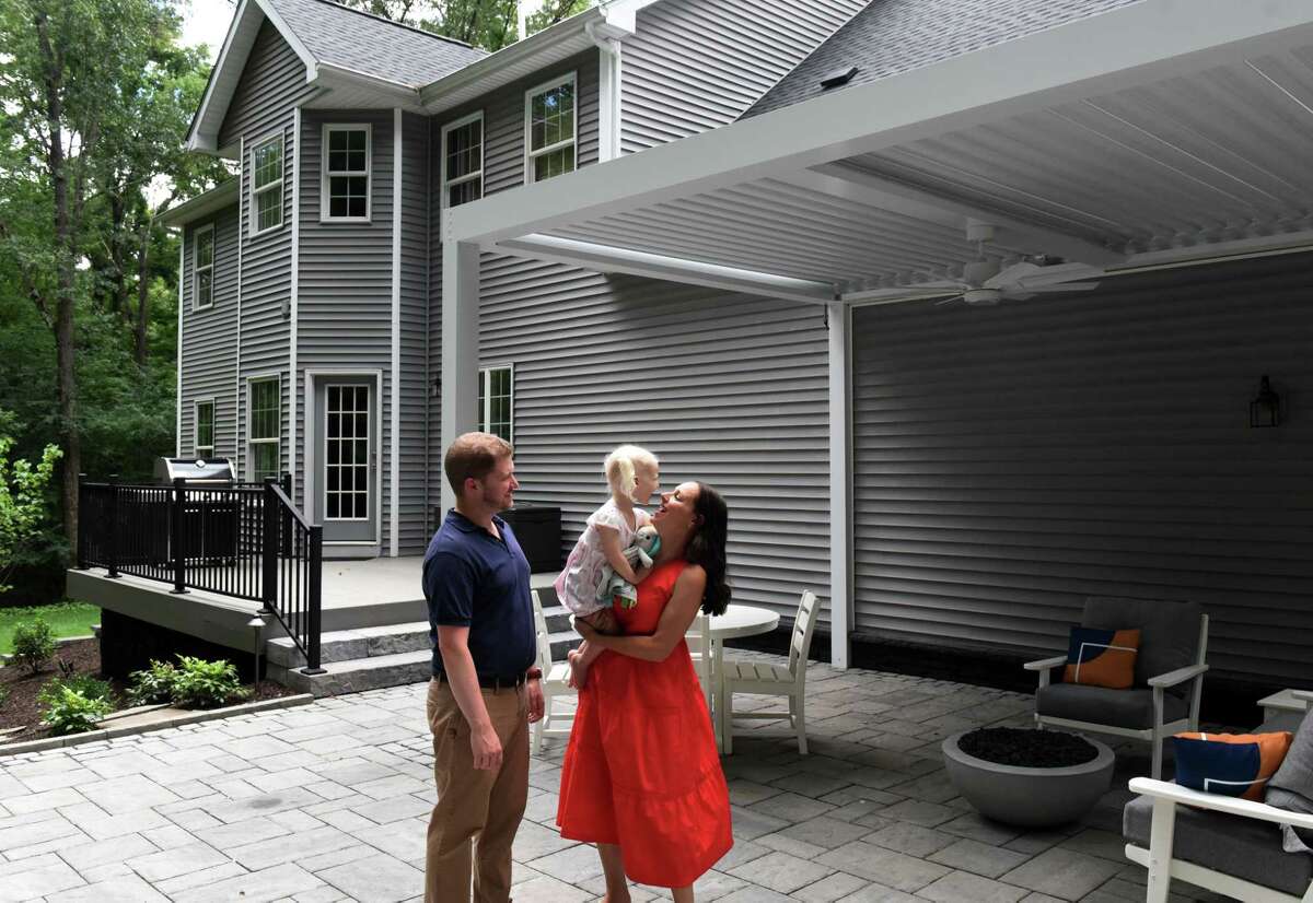 John and Kristine Brooks with daughter Addy, 2, on their rear patio on Wednesday, Aug. 10, 2022, in Niskayuna, N.Y.