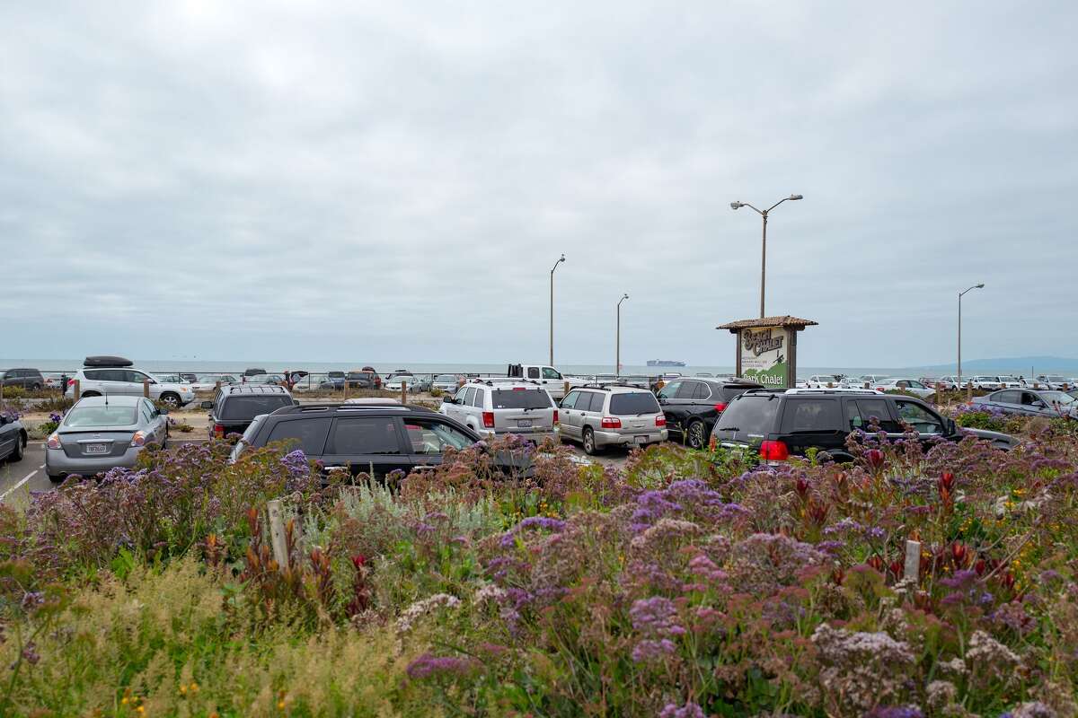 Parking lot and signage, with Ocean Beach visible, at the Beach Chalet restaurant in Golden Gate Park, San Francisco, California, August 27, 2016. (Photo via Smith Collection/Gado/Getty Images).