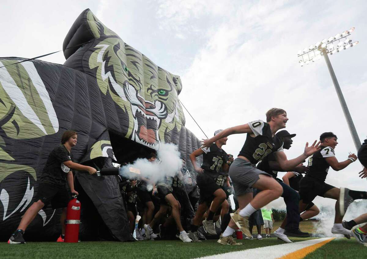 Senior athletes with the Conroe High School football program take the field during Meet the Tigers at Buddy Moorhead Stadium, Friday, Aug. 5, 2022, in Conroe. Community members saw performances by the Conroe High School’s band, Golden Girls, cheerleaders and stayed to watch the football team practice under the lights.