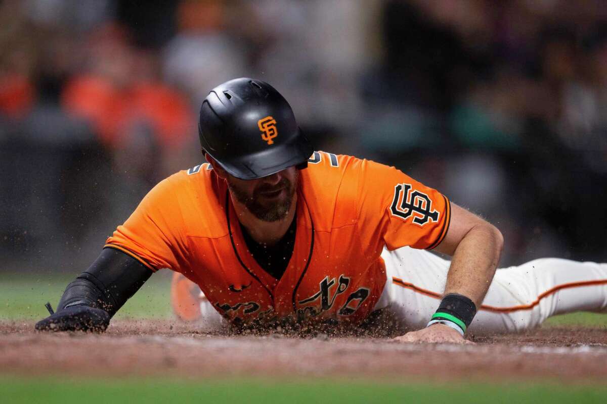 San Francisco Giants' Evan Longoria scores on a double by Luis González during the eighth inning of the team's baseball game against the Pittsburgh Pirates, Friday, Aug. 12, 2022, in San Francisco. (AP Photo/D. Ross Cameron)