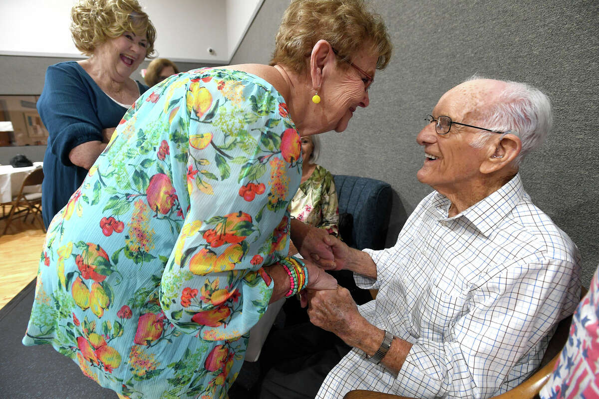 Benny Todd greets Judy Lyons as family and friends gather at First Baptist Church in Groves to celebrate his 100th birthday Saturday. Photo made Saturday, August 13, 2022. Kim Brent/The Enterprise