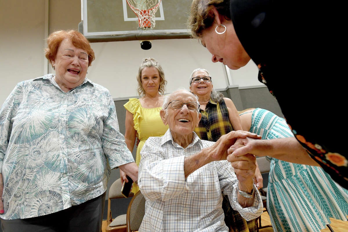 Benny Todd laughs as he is surrounded by family and friends, including Margaret (left) and Paula Hardin, wishing him a 100th happy birthday at First Baptist Church in Groves Saturday. Photo made Saturday, August 13, 2022. Kim Brent/The Enterprise
