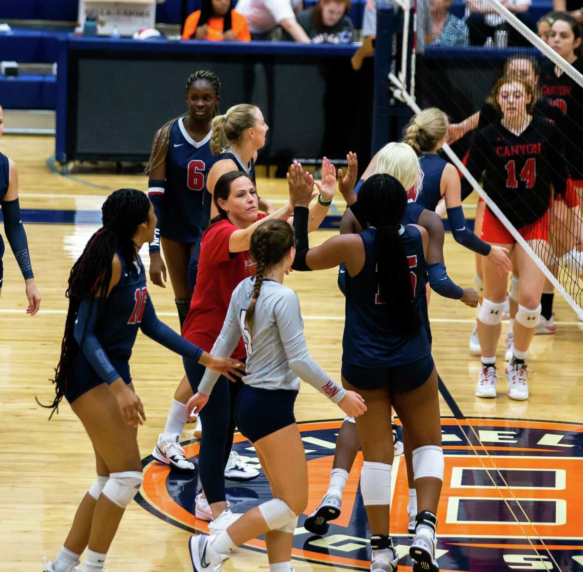 Katy Tompkins head coach Allison Merrell reacts with her players after defeating Canyon HS in the third set of the Katy/Cy-Fair volleyball tournament at Bridgeland High School in Cypress, TX, August13, 2022.