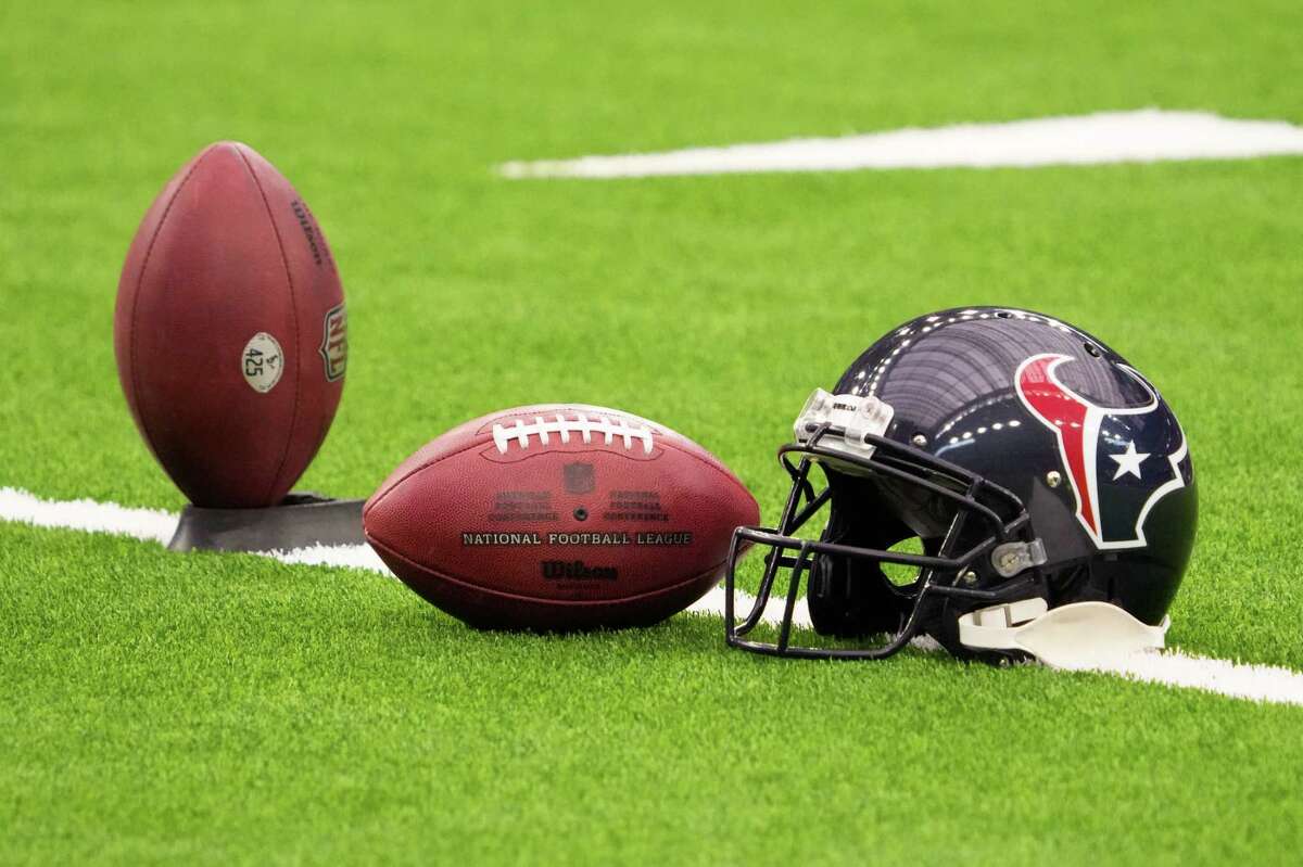 A Houston Texans helmet sits not he field before an NFL football game against the New Orleans Saints Saturday, Aug. 13, 2022, in Houston.