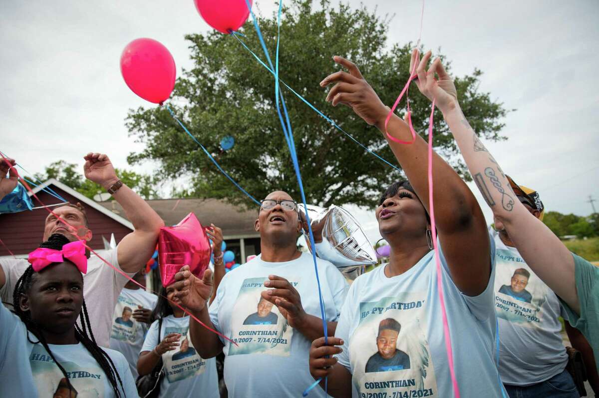 LaTonya Payne, center right, her family and friends release balloons in honor of her late son during a celebration Saturday, Aug. 13, 2022, at her home in Houston. They gathered to celebrate the life of Corinthian "Mister" Giles on the weekend after what would have been his 15th birthday. He died of cancer in 2021. Payne lives about a hundred yards from the Union Pacific rail yard in Fifth Ward, where officials have identified higher rates of some cancers than expected.