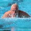 Mike Slaughter churns water as he swims to breaststroke Saturday at the Summers-Port Alumni Meet. Slaughter is the former Marquette Catholic High School principal and former Marquette teacher and football coach.