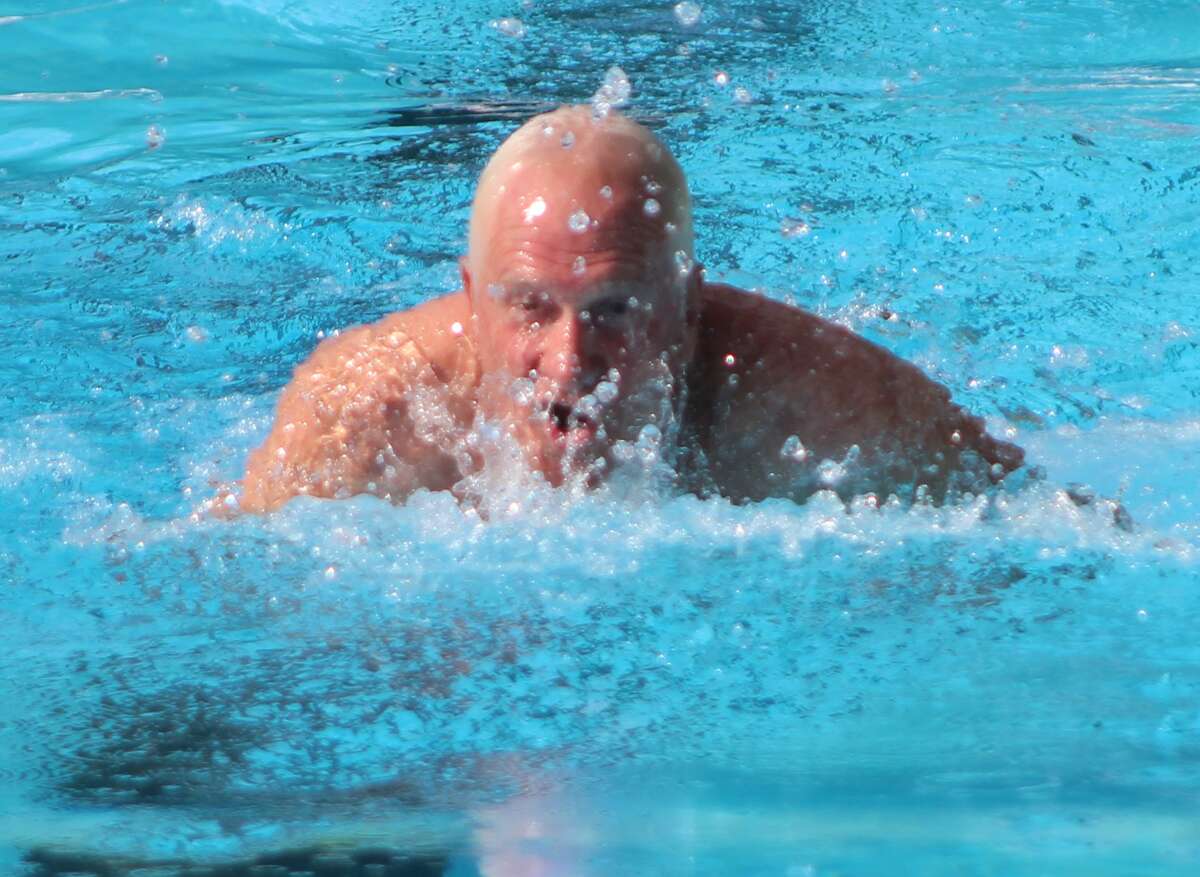 Mike Slaughter churns water as he swims the breaststroke Saturday at the Summers-Port Alumni Meet. Slaughter is the former Marquette Catholic High School principal and former Marquette teacher and football coach.