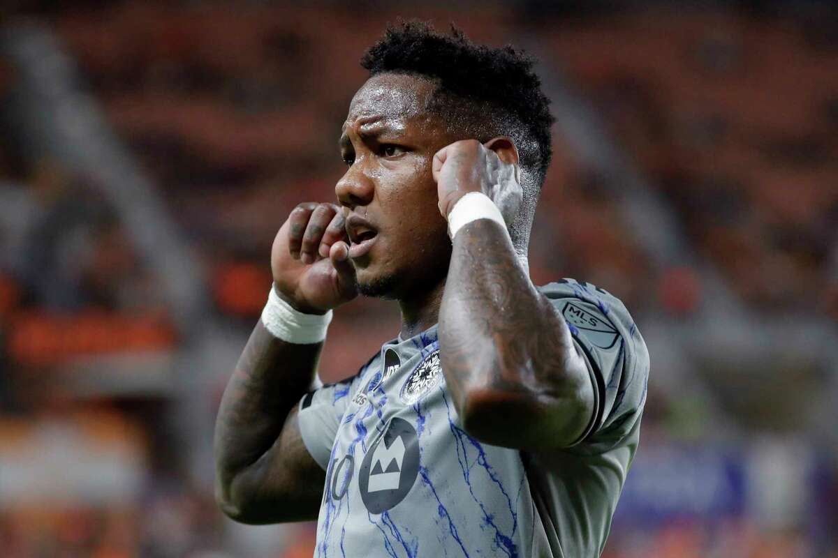 CF Montreal forward Romell Quioto plugs his ears against booing Houston Dynamo fans in reaction after scoring a goal during the first half of an MLS soccer match Saturday, Aug. 13, 2022, in Houston. (AP Photo/Michael Wyke)