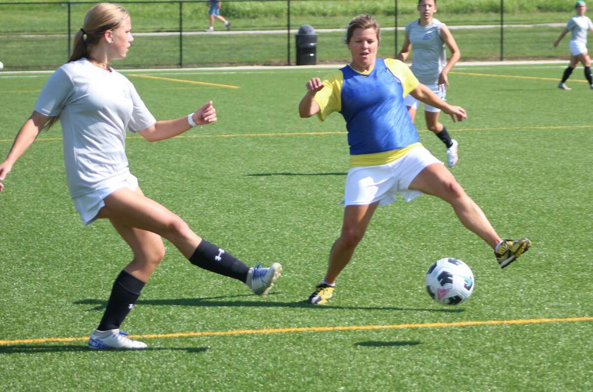 LCCC women's soccer alum Roxanne Strange, right, defends against current LCCC player Olivia Mouser during Saturday's LCCC women's alumni soccer game at Glazebrook Park.