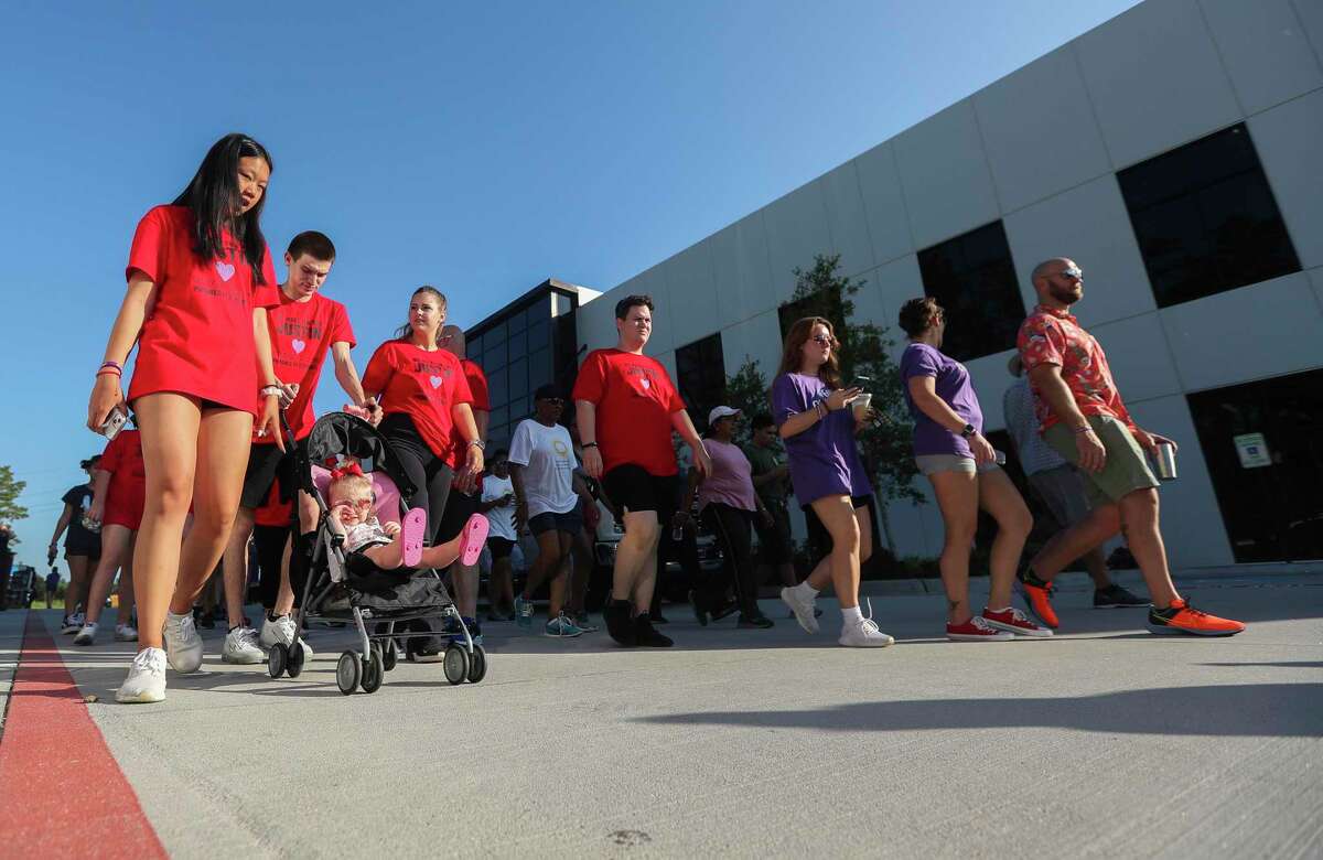 Participants begin their 4,000 walk in remembrance for the over 4,000 Texans who died last year due to opioid overdoses during the annual Overdose Awareness Walkathon, Saturday, Aug. 13, 2022, in Conroe.