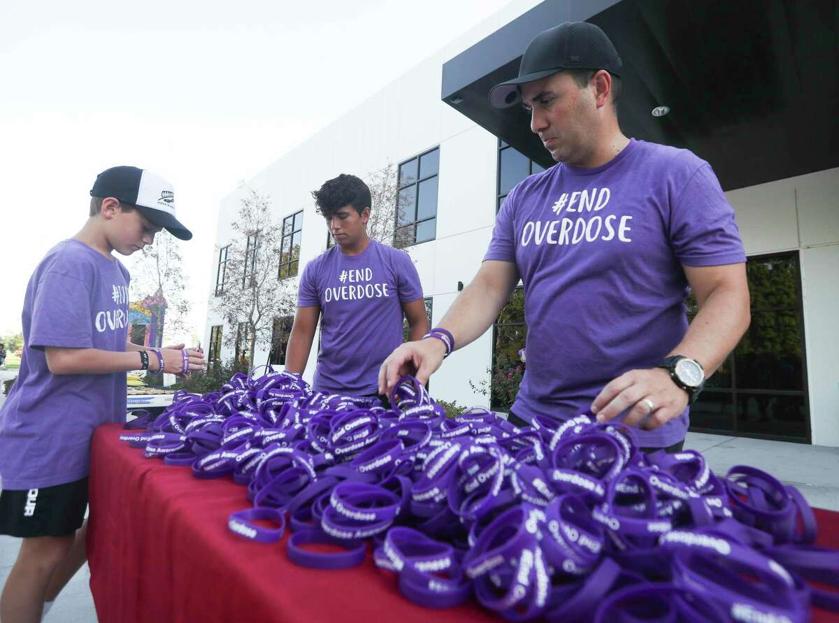 Kala Eulitt, right, sorts through purple wristbands during the annual Overdose Awareness Walkathon.