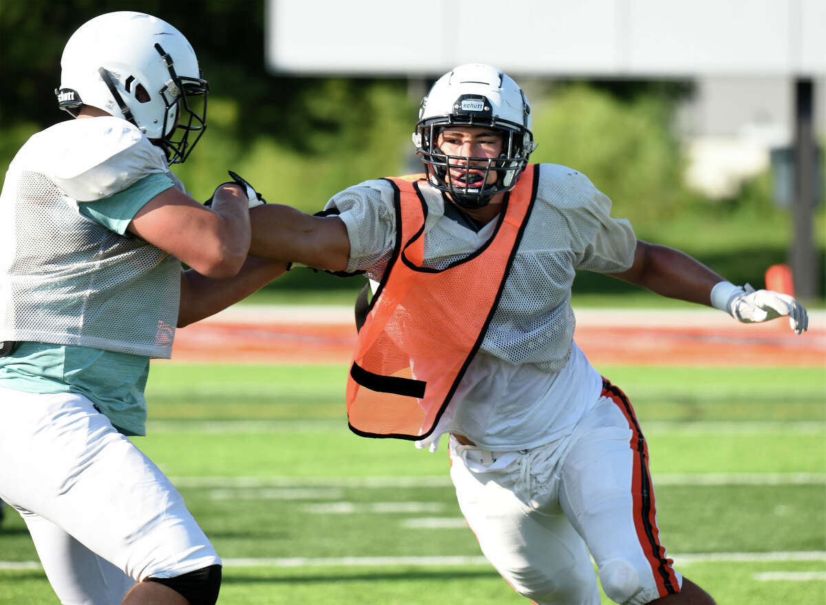 Edwardsville defensive end Iose Epenesa runs a drill during a practice for the Tigers inside the District 7 Sports Complex on Saturday.