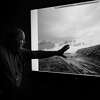 Wes Monier, chief hydrologist for Turlock Irrigation District, shows a photo from 1997 when floodwaters were released from the Don Pedro Reservoir through the dam's spillway, July 28, 2022. A coming superstorm — really, a rapid procession of what scientists call atmospheric rivers — will be the ultimate test of the dams, levees and bypasses California has built to impound nature’s might. (Erin Schaff/The New York Times)