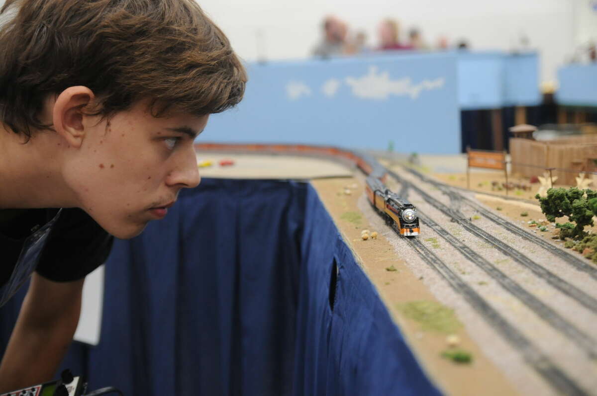 Jake Seitz of Indianapolis keeps a close eye on the small-scale train he waas operating on a large layout at the National Model Railroad Association over the weekend in Collinsville.
