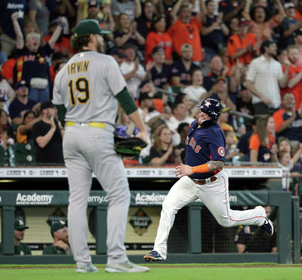 HOUSTON, TEXAS - AUGUST 14: Christian Vazquez #9 of the Houston Astros scores on a double by Jose Altuve #27 in the second inning against the Oakland Athletics at Minute Maid Park on August 14, 2022 in Houston, Texas. (Photo by Bob Levey/Getty Images)