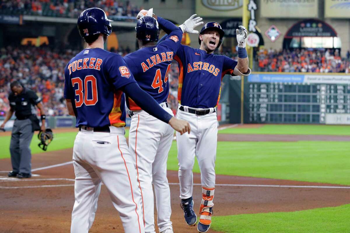 Houston Astros' Kyle Tucker (30) and Yordan Alvarez (44) celebrate with Alex Bregman, right, after Bregman's two-run home run during the first inning of a baseball game against the Oakland Athletics, Sunday, Aug. 14, 2022, in Houston.
