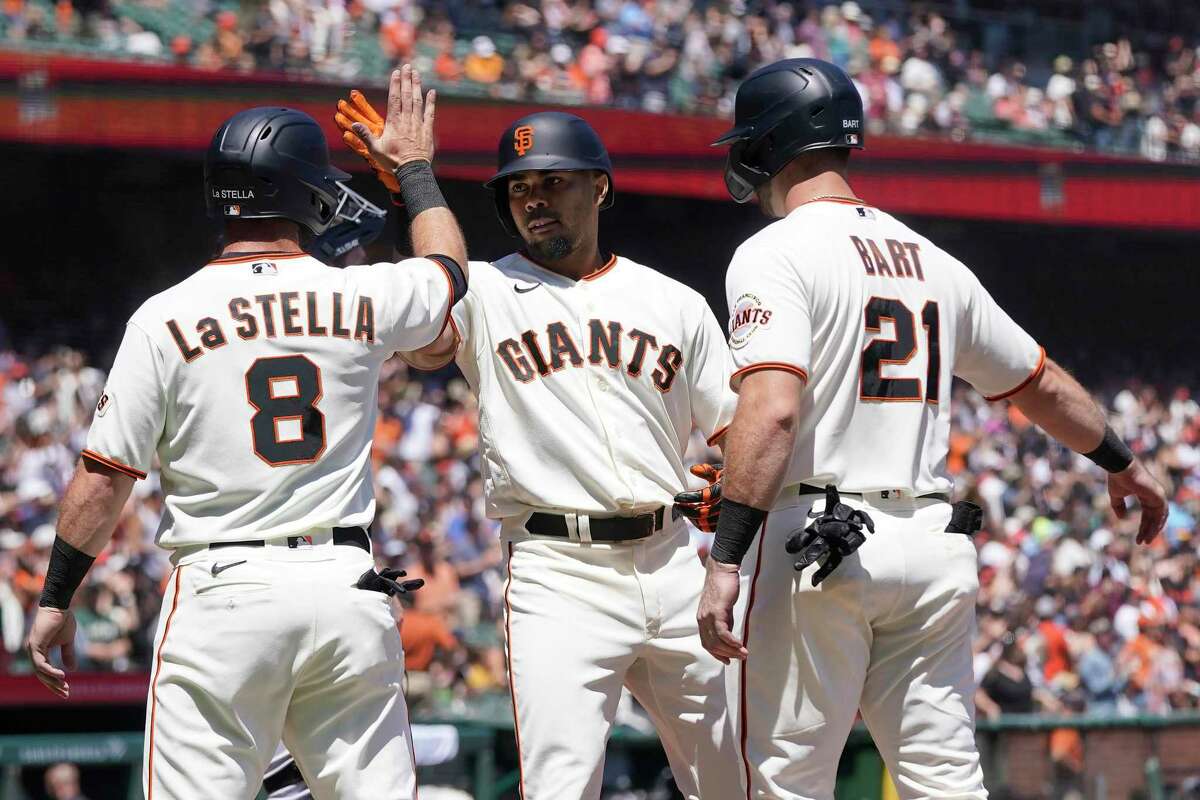 San Francisco Giants' LaMonte Wade Jr., middle, celebrates after hitting a three-run home run that scored Tommy La Stella (8) and Joey Bart (21) during the second inning of a baseball game against the Pittsburgh Pirates in San Francisco, Sunday, Aug. 14, 2022. (AP Photo/Jeff Chiu)