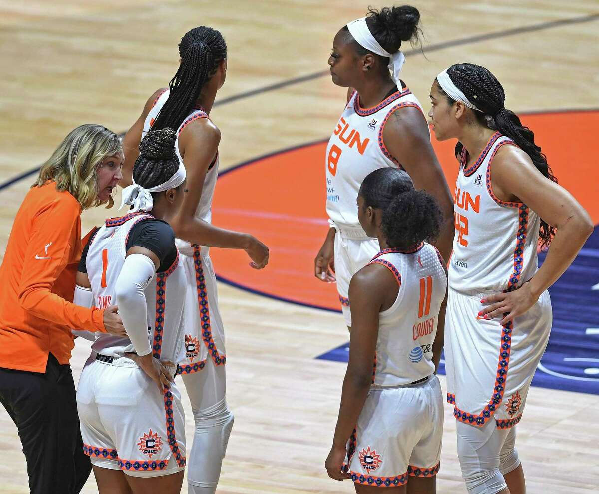 Connecticut Sun assistant coach Brandi Poole gives instructions to guard Odyssey Sims (1) as the team heads back to the court from a timeout against the Minnesota Lynx on Sunday.