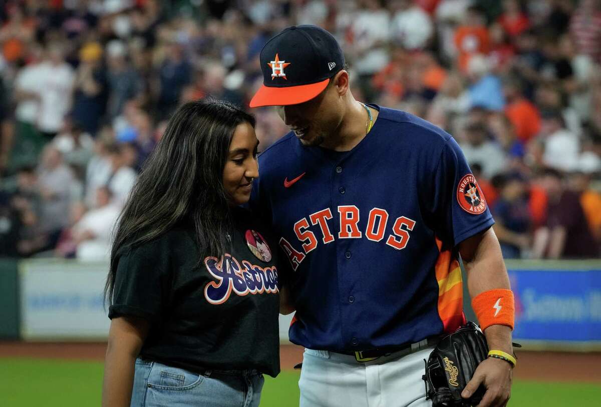 Faith Mata talks with Houston Astros left fielder Aledmys Diaz (16) after she threw a ceremonial first pitch before an MLB game Sunday, Aug. 14, 2022, at Minute Maid Park in Houston.