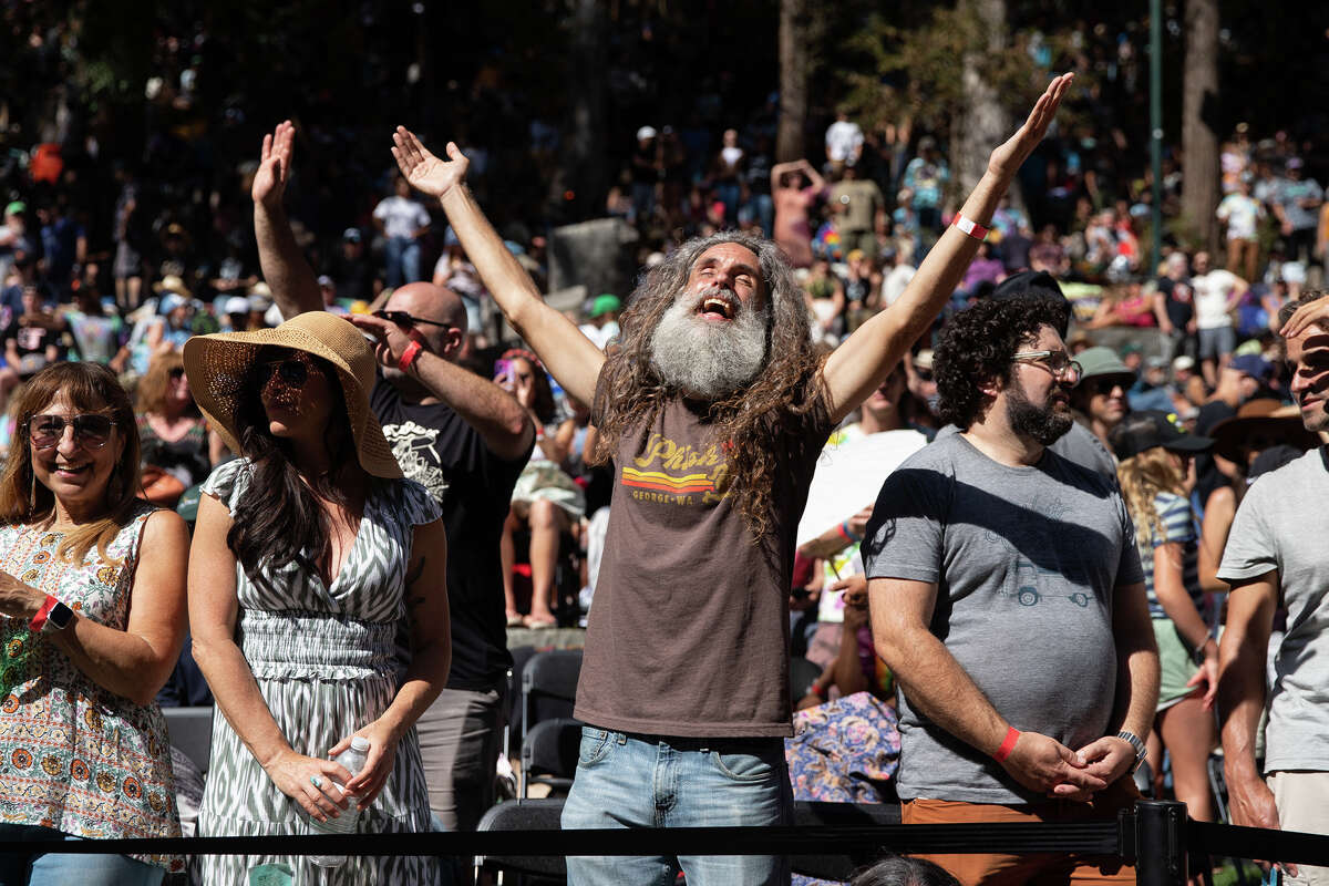 A spectator smiles and dances as Phil Lesh & Friends perform at the last concert of the 85th Stern Grove Festival in San Francisco on Aug. 14, 2022. 