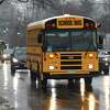 A Greenwich school bus drives through Cos Cob en route to pick up students at dismissal in Greenwich, Conn., photographed on Thursday, Feb. 3, 2022.