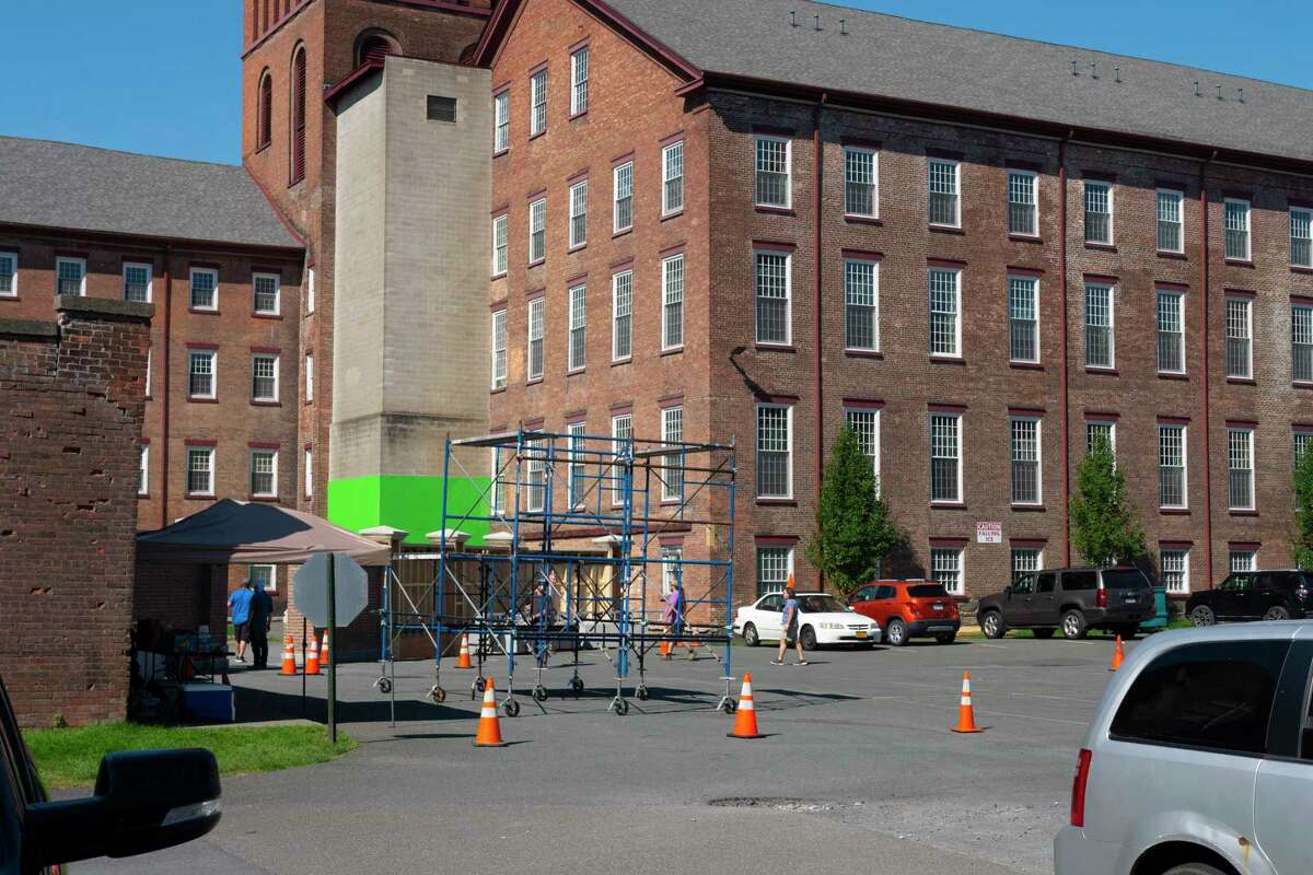 A view of crews setting up for filming at the Lofts at Harmony Mills on Monday, Aug. 15, 2022, in Cohoes, N.Y. Initial concerns about handicap parking have been resolved by staff. (Paul Buckowski/Times Union)