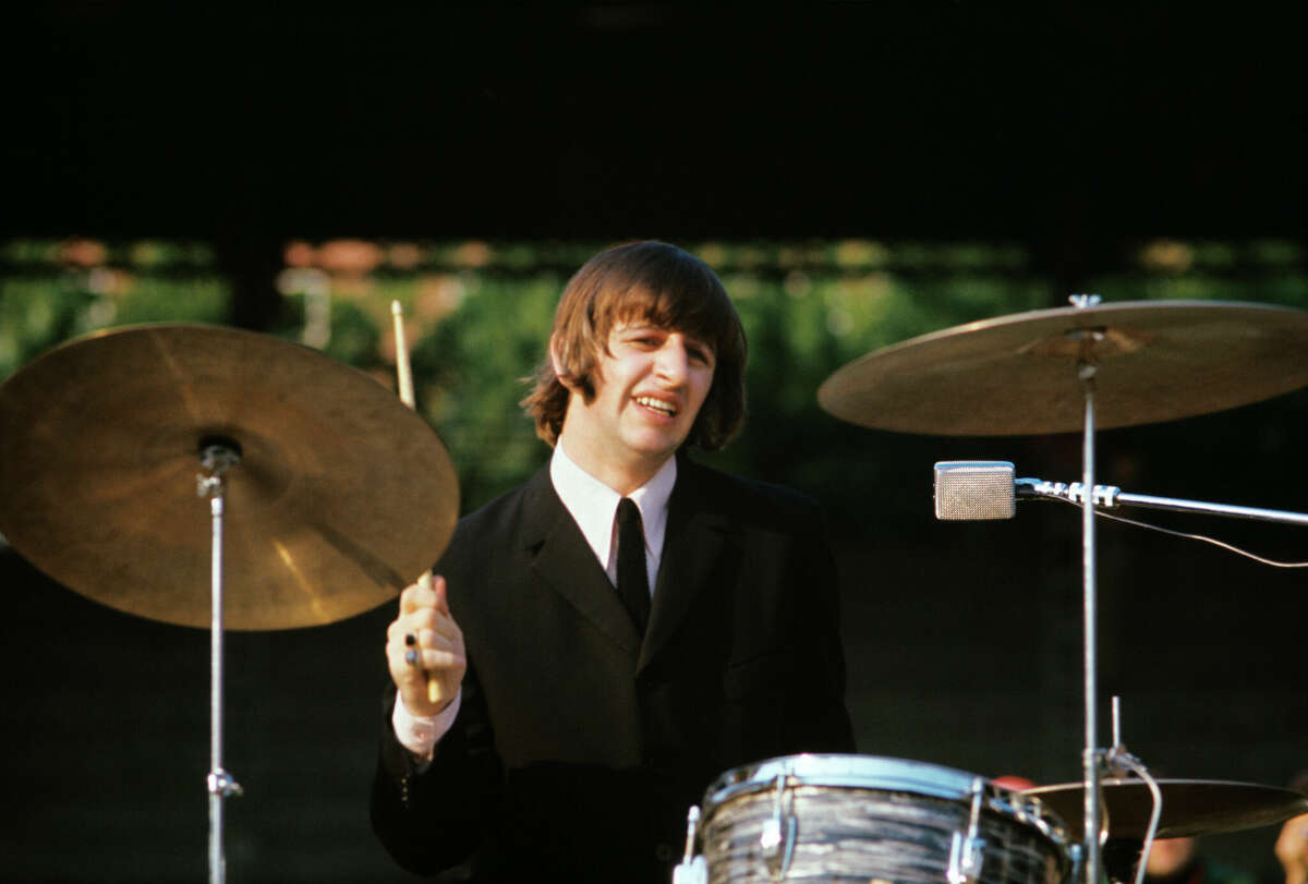 Ringo Starr plays drums during a Beatles concert.
