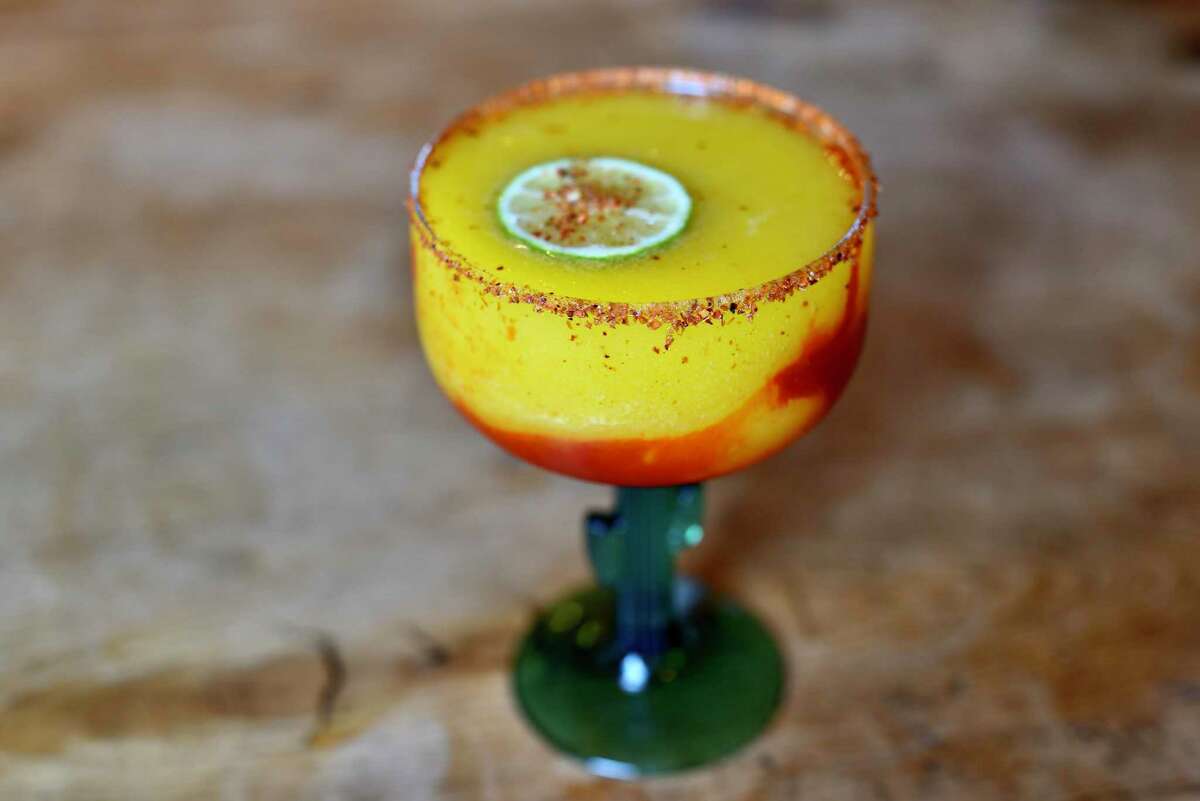 Molina’s Cantina offers a Mangonada Margarita, a traditional tequila froth with a spicy chamoy swirl and a rim of Tajin.
