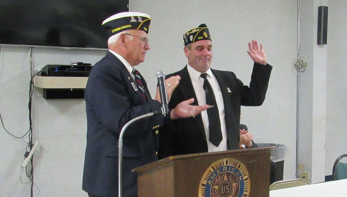 Outgoing commander Ron Swaim, left, acknowledges new commander Wes Sterling during Sunday’s installation of officers at Edwardsville American Legion Post 199.