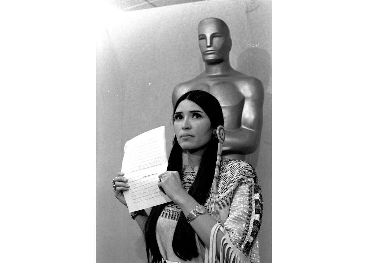 FILE - Sacheen Littlefeather appears at the Academy Awards ceremony to announce that Marlon Brando was declining his Oscar as best actor for his role in "The Godfather," on March 27, 1973. The move was meant to protest Hollywood's treatment of American Indians. Nearly 50 years later, the Academy of Motion Pictures Arts and Sciences has apologized to Littlefeather for the abuse she endured. The Academy Museum of Motion Pictures on Monday said that it will host Littlefeather, now 75, for an evening of “conversation, healing and celebration” on Sept. 17.