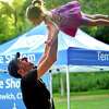 Andrew Levy swings his daughter Mae, 2, into the air during Temple Sholom's Shabbat on the Sound at Tod's Point Park in Greenwich on Friday. The event started with a Young Family Shabbat for kids and then a Musical Shabbat for all ages afterwards.