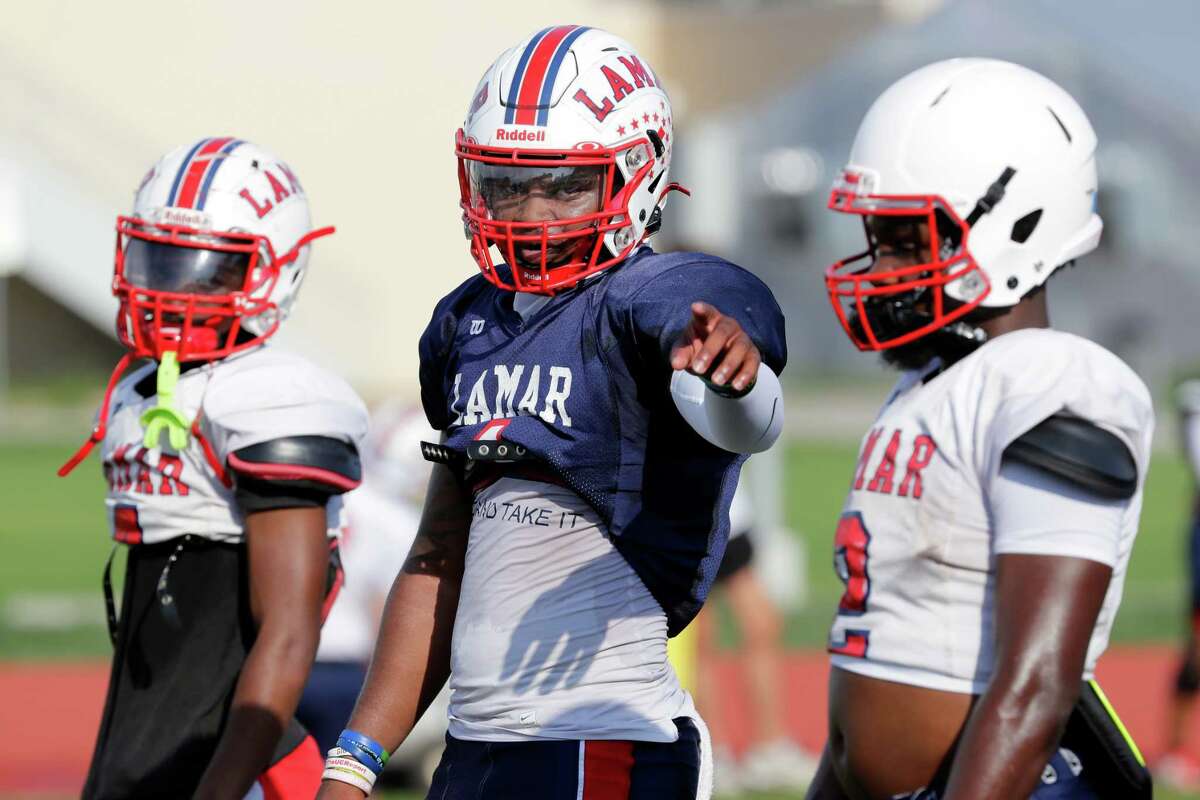 Lamar quarterback Kenneth Rosenthal, middle, between drills at their high school football practice on the campus facilities Wednesday, Aug. 10, 2022 in Houston, TX.