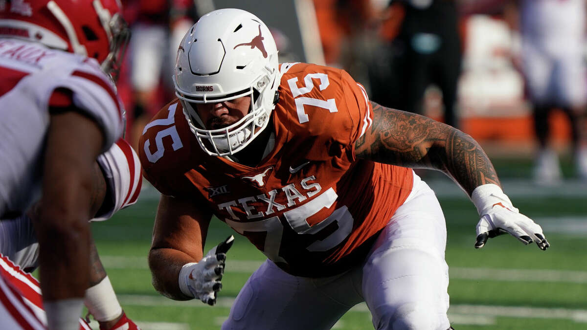 Texas' Junior Angilau, blocking against Louisiana last season, is out for 2022 with a knee injury.