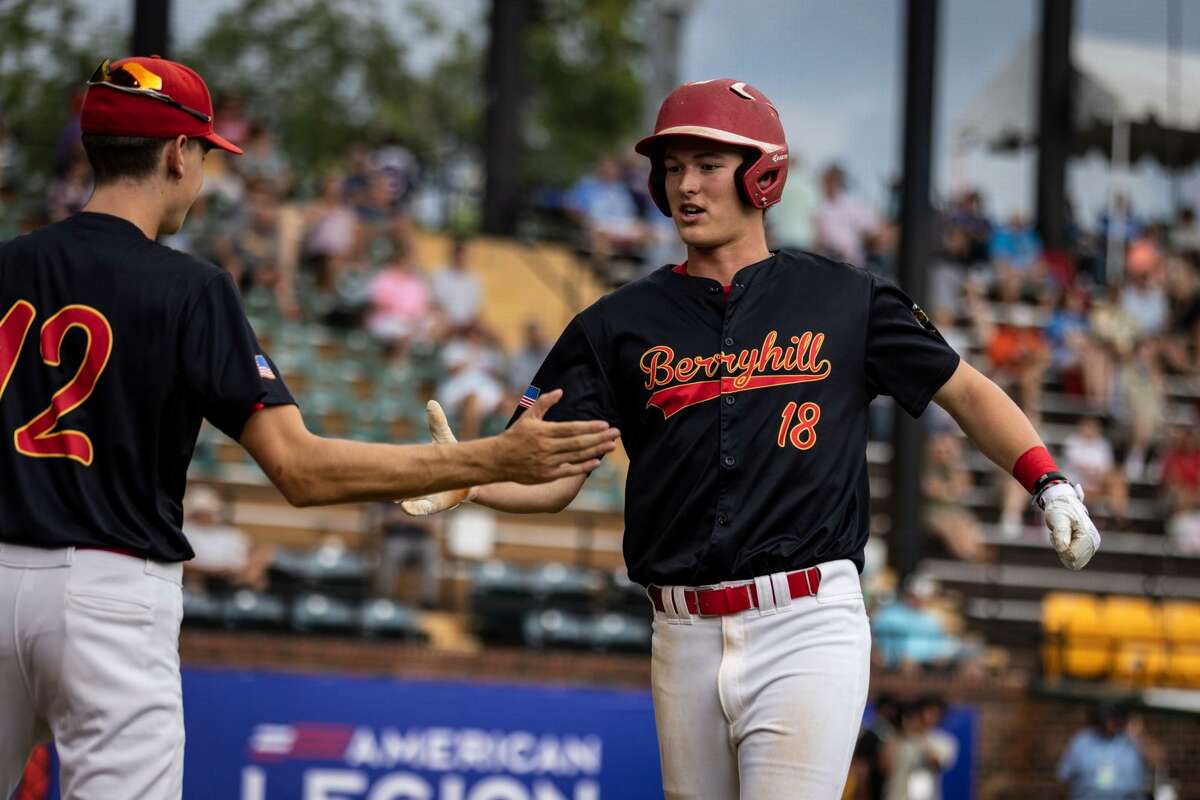 Berryhill Post 165's Jack Bakus (right) is greeted by teammate Lane Kloha after scoring a run during Monday's American Legion Baseball World Series semifinal against Troy (Ala.) in Shelby, N.C.