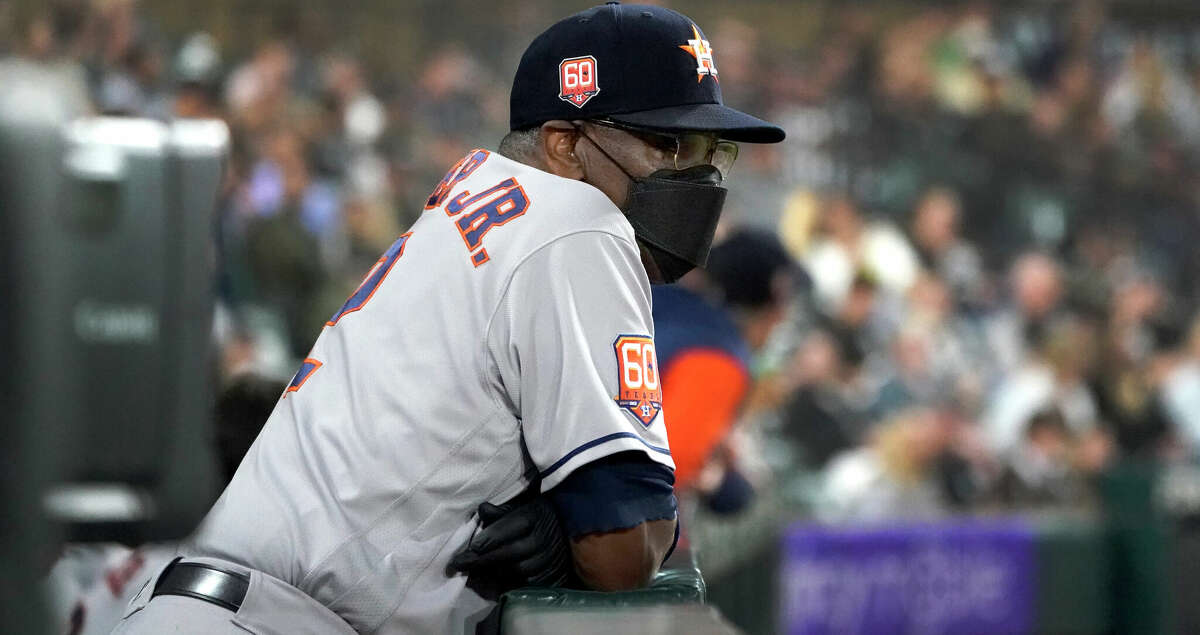 Houston Astros manager Dusty Baker Jr. wears a protective mask as he watches from the dugout during the fifth inning of the team's baseball game against the Chicago White Sox on Monday, Aug. 15, 2022, in Chicago. (AP Photo/Charles Rex Arbogast)