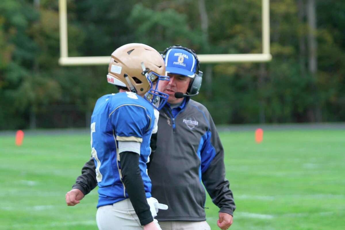 Onekama coach John Neph talks with a player during a game in the 2021 season.