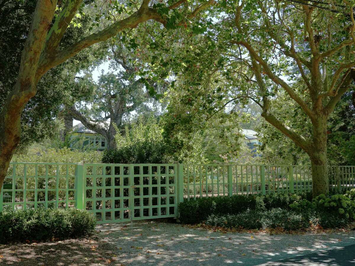 Hedges and a gate along a property in Atherton, Calif. on Aug. 11, 2022. Some wealthy residents of Atherton are speaking out against a proposal to build multi-family townhomes in the community. (Jim Wilson/The New York Times)