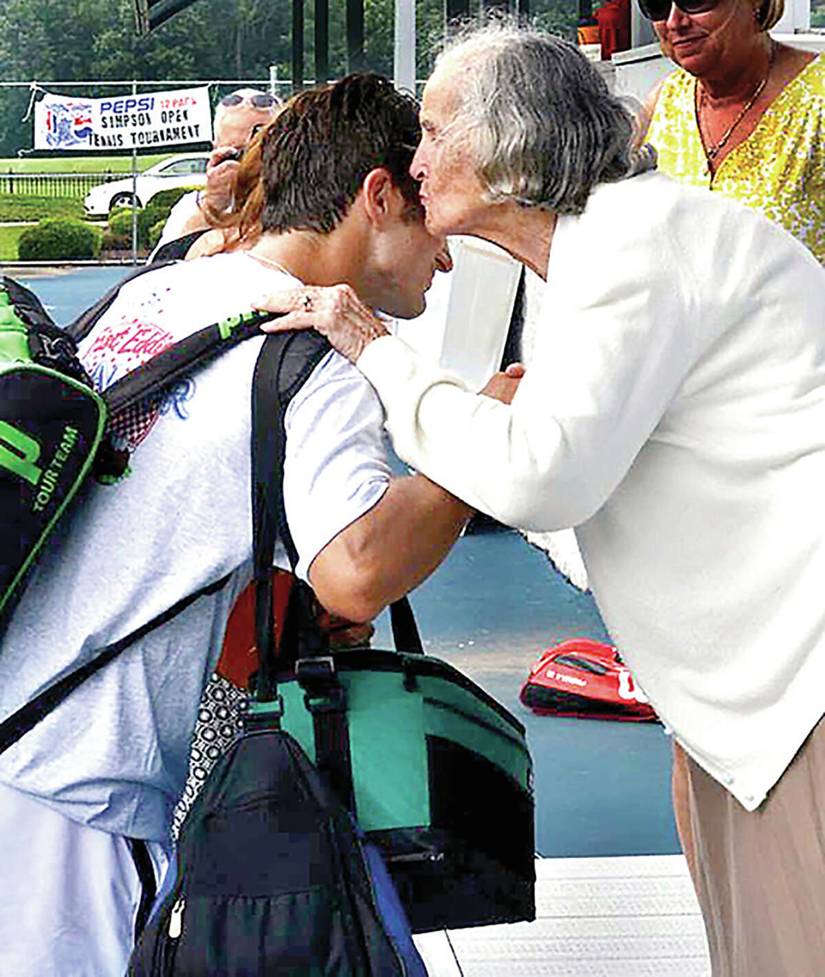 A Bud Simpson Tennis Tournament  winner receives a congratulatory kiss from the late Antigone "Andy" Simpson in 2015.
