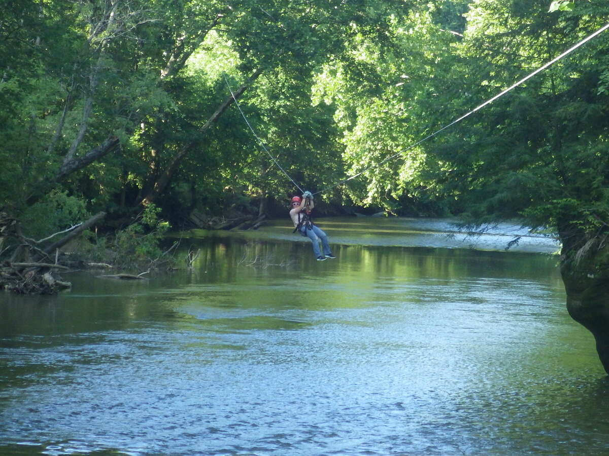 A visitor zip-lines across the Hocking River in the Hocking Hills area in southeastern Ohio.