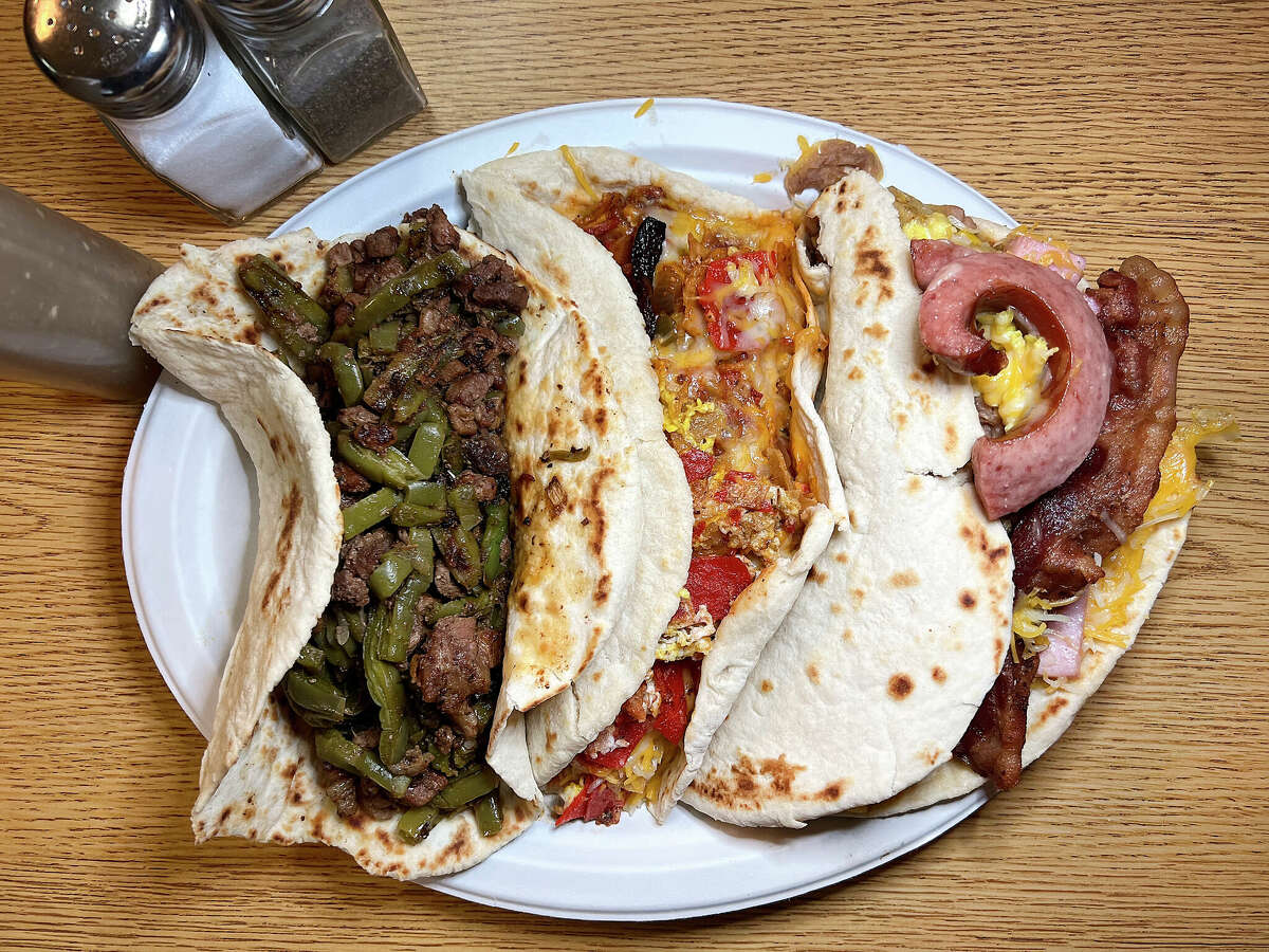 Taco options at Teran's Restaurant on East Houston Street in San Antonio include, from left, nopalito al carbon, chilaquiles and Teran's Taco with eggs, bacon, sausage, cheese, ham, beans and potatoes. 