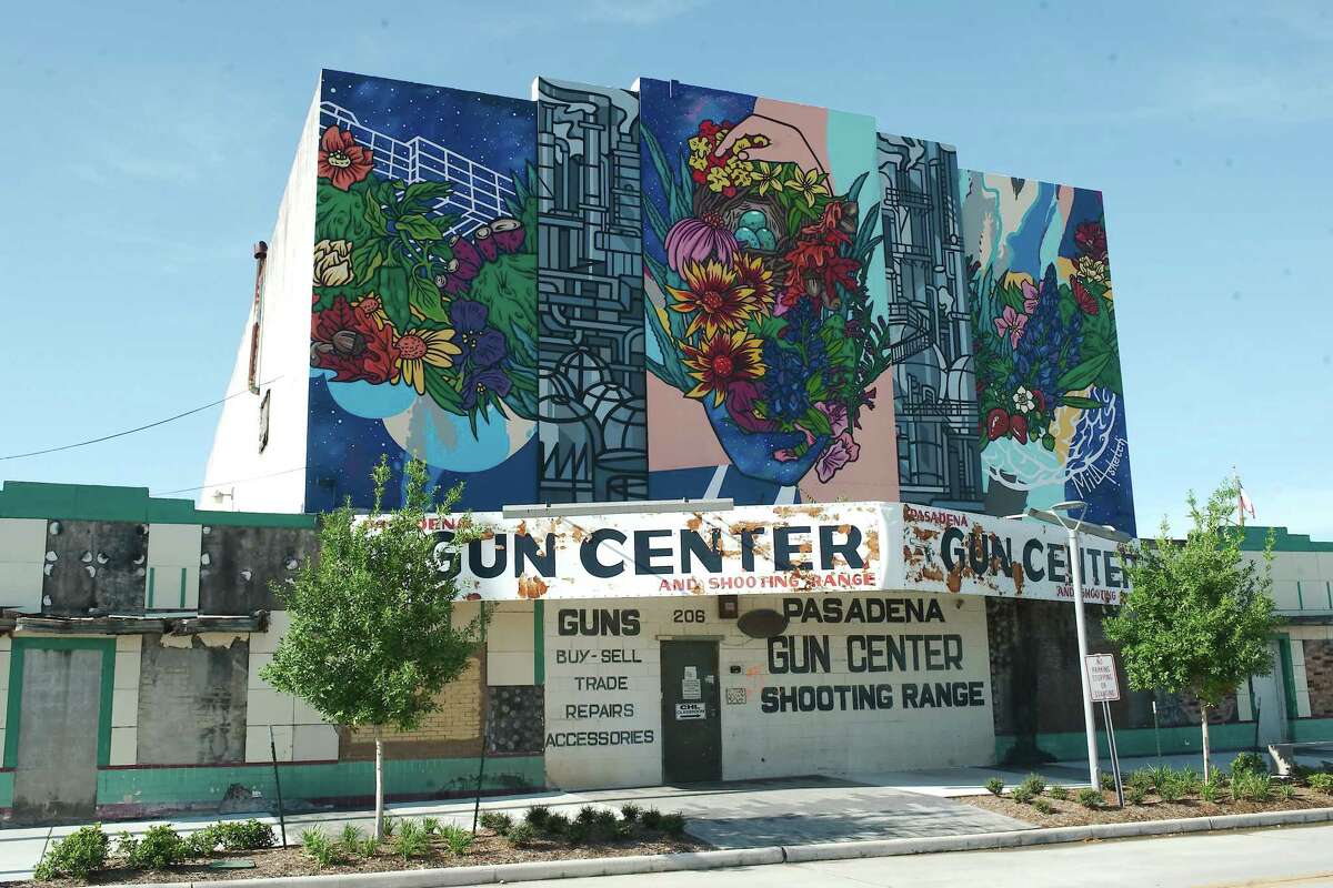 Bright murals contrast with the rundown exterior of the Pasadena Gun Center building, representing both the neighborhood's recent hard times and the promise for revitalization. Landscaped and improved walkways near the building are examples of improvements along West Shaw Avenue near Main Street in Pasadena.