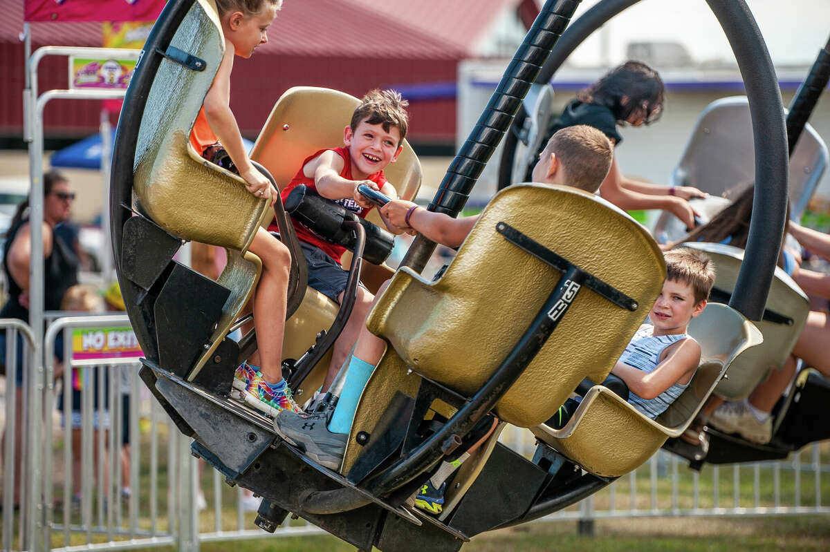 Stanford resident Wesson Kelley, 7, spins on a carnival ride at the Midland County Fair on Aug. 16, 2022 at the Midland Fairgrounds.