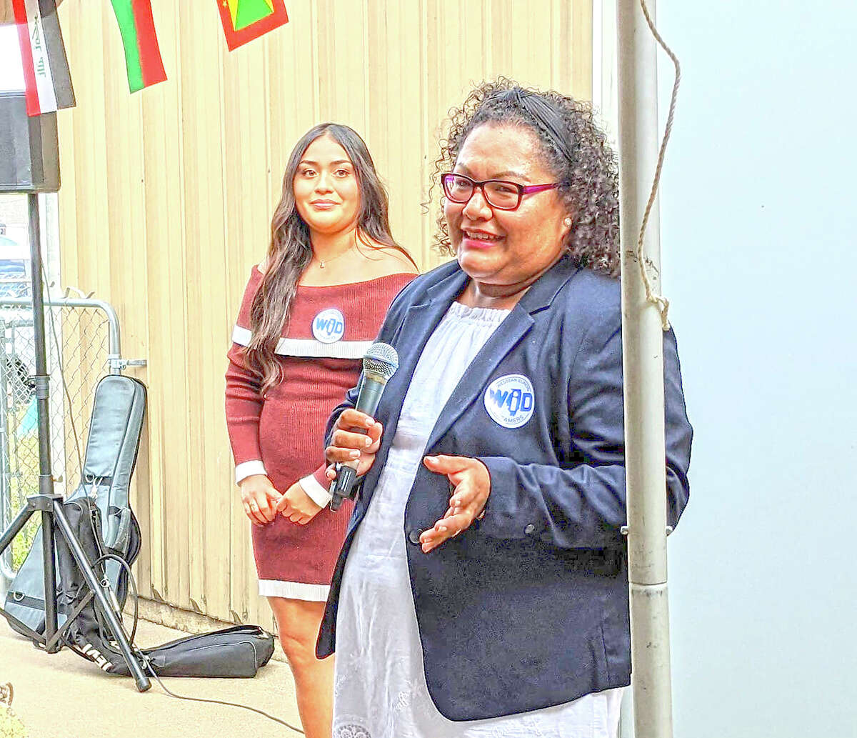 Vianey Torres (right), co-director of the Western Illinois Dreamers immigrant welcome center in Beardstown, speaks during an opening reception for the center as co-director Kiara Perez looks on.